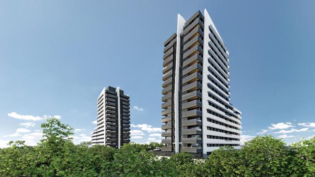 La zona verde discurre alrededor de una nueva urbanización.