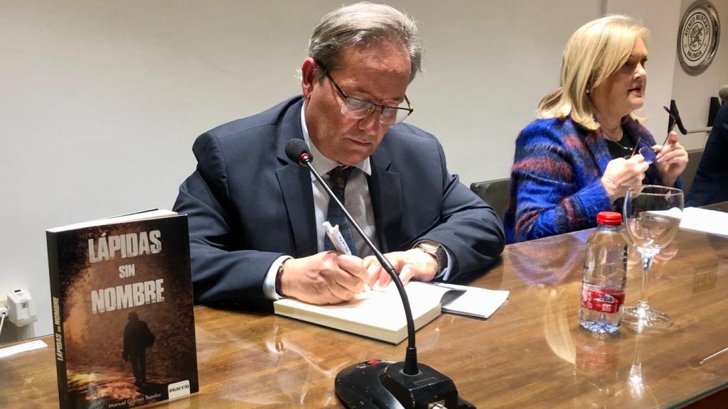 Manuel Gómez Tejedor firma un ejemplar de 'Lápidas sin nombre'. EE