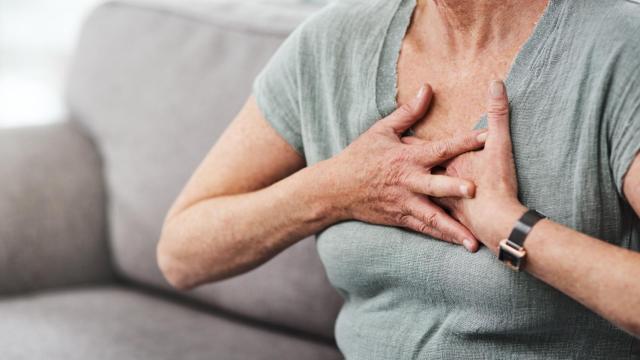 Una mujer se pone la mano en el pecho porque siento un fuerte dolor, en una imagen de archivo.