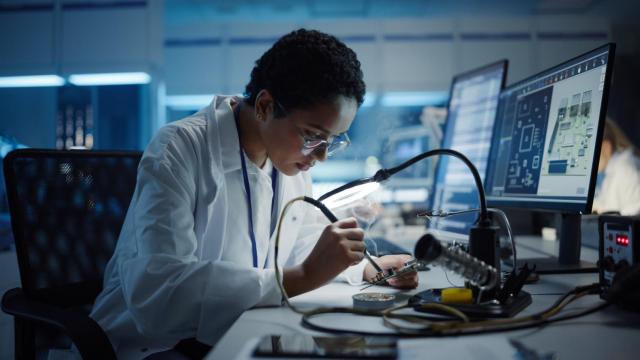 Imagen de archivo de una ingeniera negra haciendo una soldadura sobre un chip (iStock).