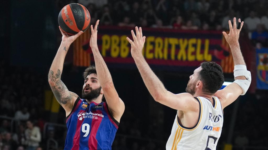 Ricky Rubio lanza a canasta ante la presencia de Rudy Fernández.