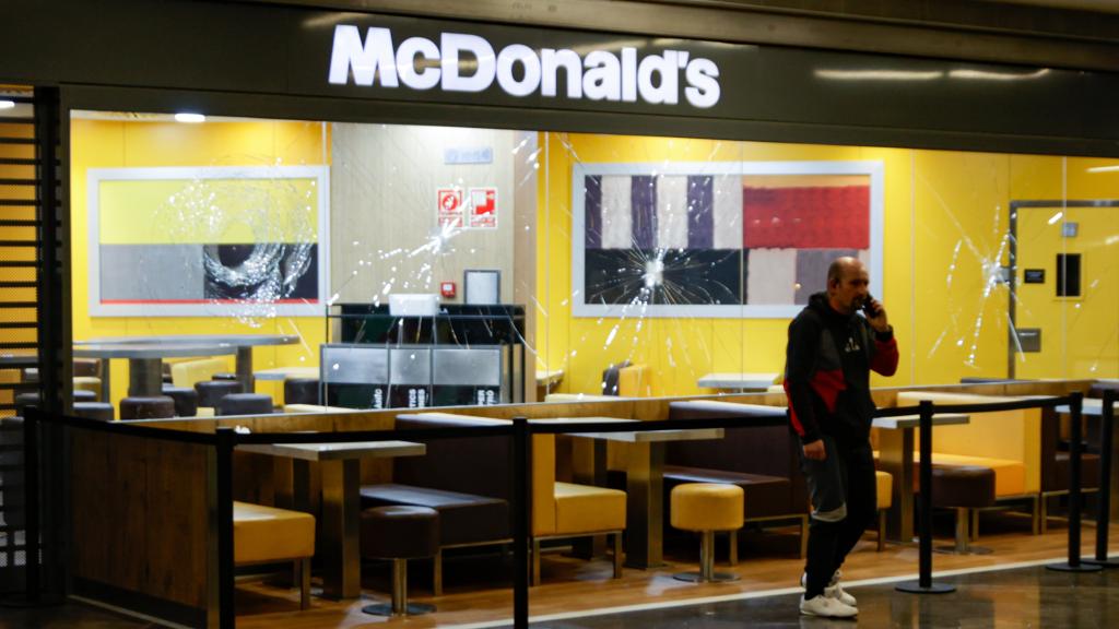 Destrozos en un escaparate causados por el varón que entró a hachazos en el centro comercial de Badalona.