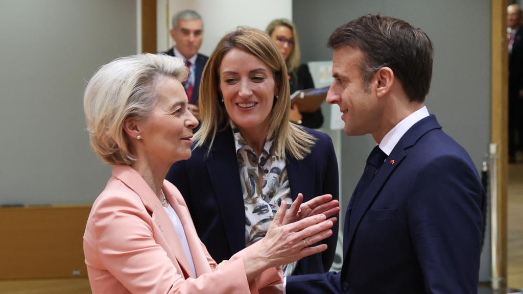 Ursula von de Leyen conversa con Emmanuel Macron bajo la mirada atenta de Roberta Metsola durante un Consejo Europeo