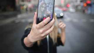 Una joven se hace un 'selfie' con la cámara trasera de su teléfono.