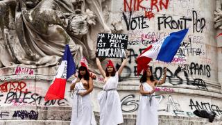 Three women demonstrate against the far-right National Reunion in the Place de la République in Paris.