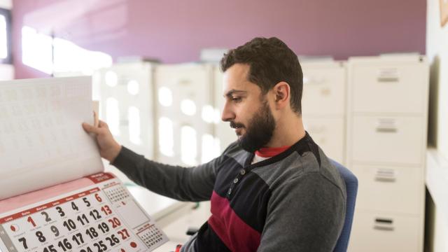 Un hombre mirando a un calendario.