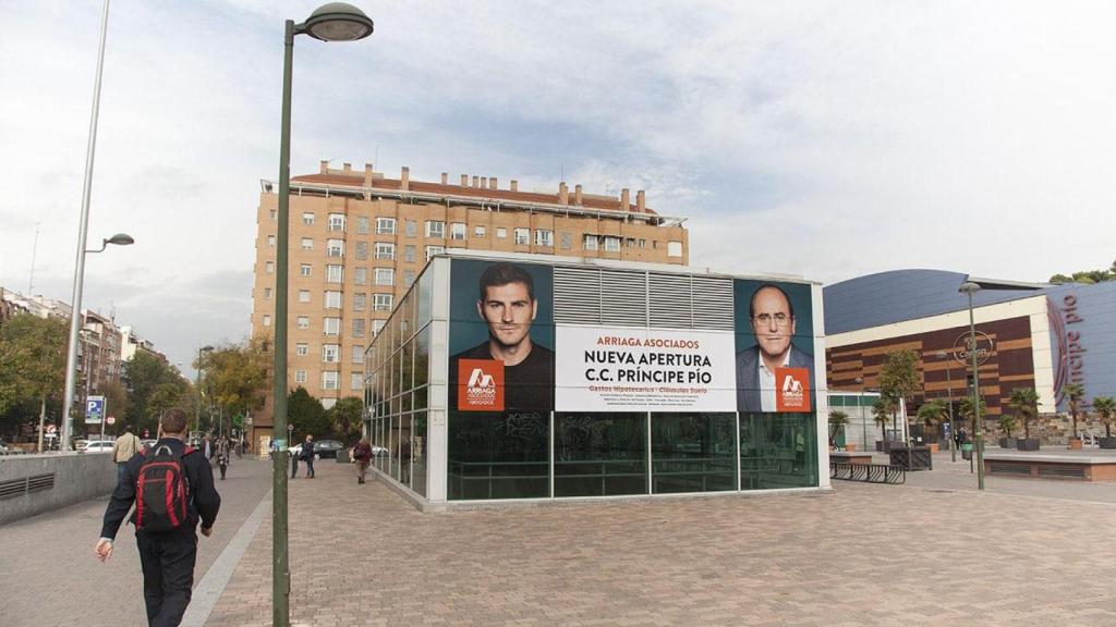 En una imagen de archivo, un cartel anuncia la llegada de Arriaga Asociados al Centro Comercial de Príncipe Pío. Jesús María e Iker Casillas lo protagonizan.