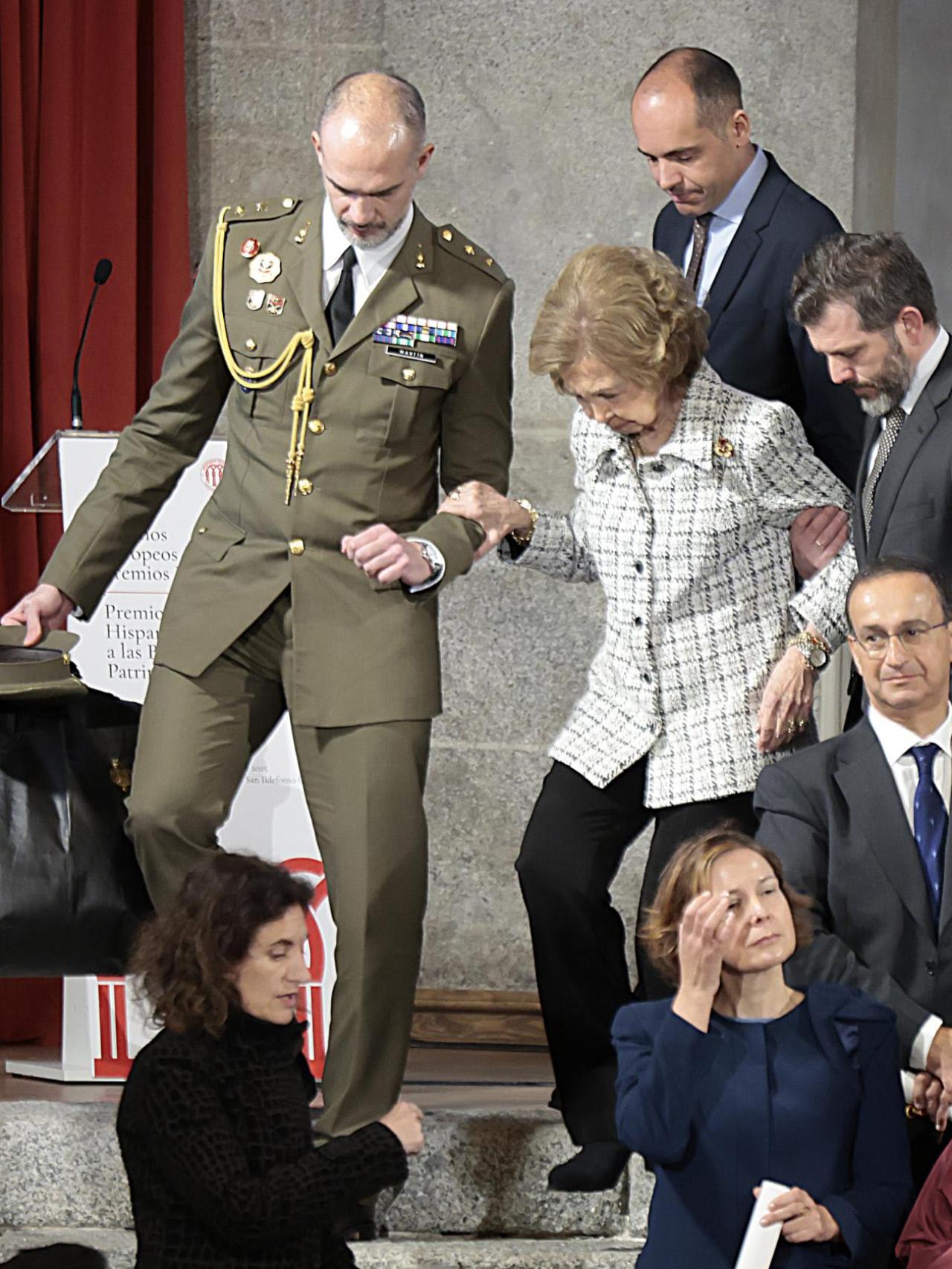 La reina Sofía, ayudada para bajar las escaleras, tras el acto.
