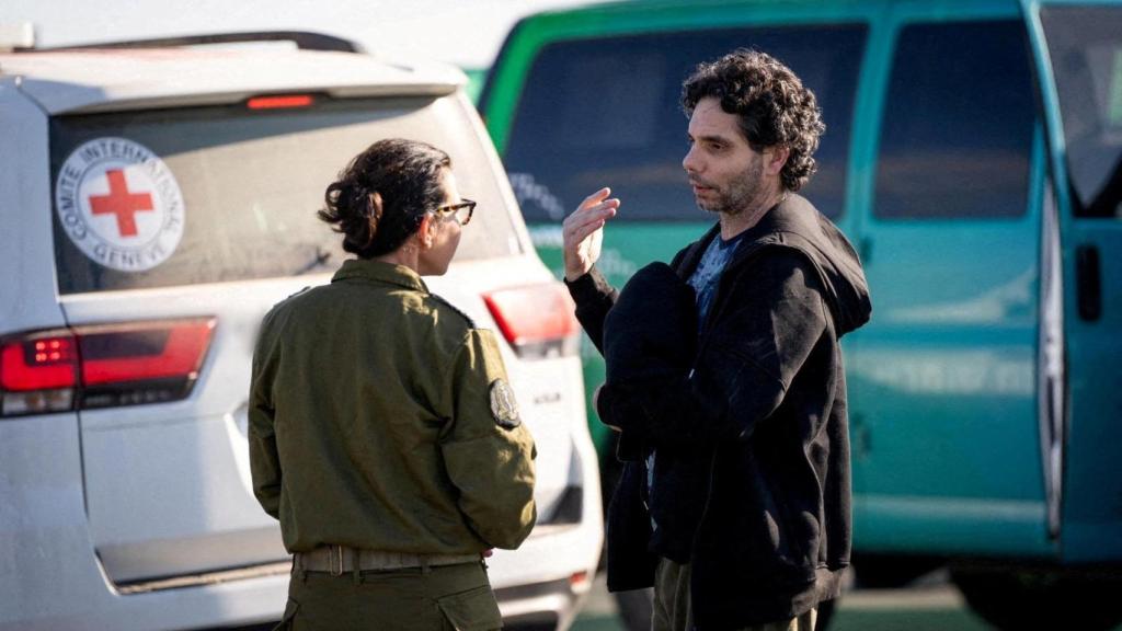 Ofter Calderon con una militar israelí tras ser liberado por Hamás