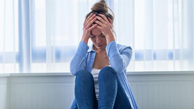 Mujer con ansiedad sobre la cama.
