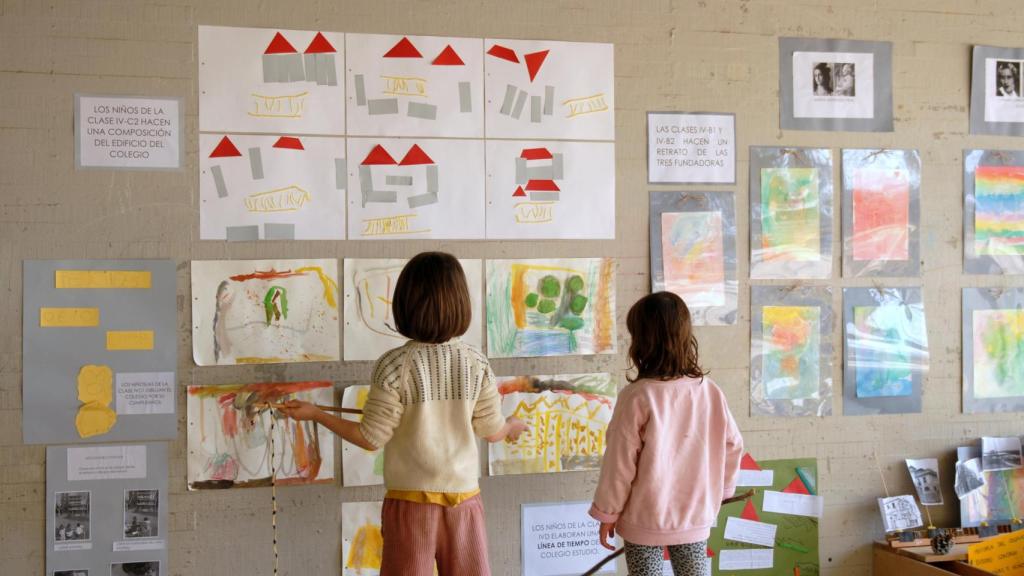 Niños de Infantil observando sus composiciones del edificio del colegio