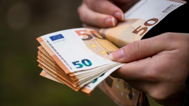 Una persona cuenta billetes de 50 euros