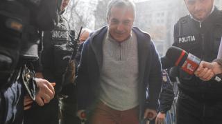 Călin Georgescu este miércoles escoltado por policías a su llegada a la Fiscalía tras ser detenido.