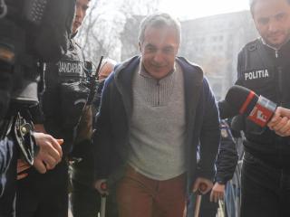 Călin Georgescu este miércoles escoltado por policías a su llegada a la Fiscalía tras ser detenido.