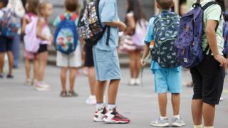 Niños esperando a la entrada de un colegio.