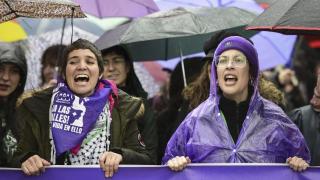 Dos jóvenes en la cabecera de la manifestación de la Comisión 8M en Madrid.
