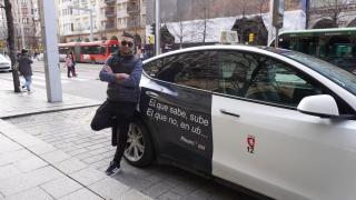 Suly, taxista local, junto a su vehículo con el mensaje contra las VTC.