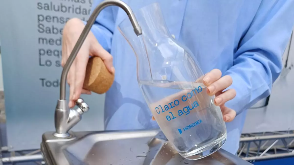 Una persona rellena una botella de agua.