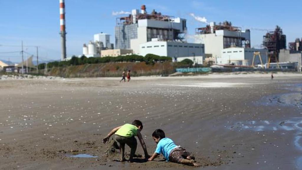 Niños juegan en la arena de la playa Las Ventanas junto a la central termoeléctrica AES Gener en Puchuncaví, Región de Valparaíso, Chile, el 8 de octubre de 2019.