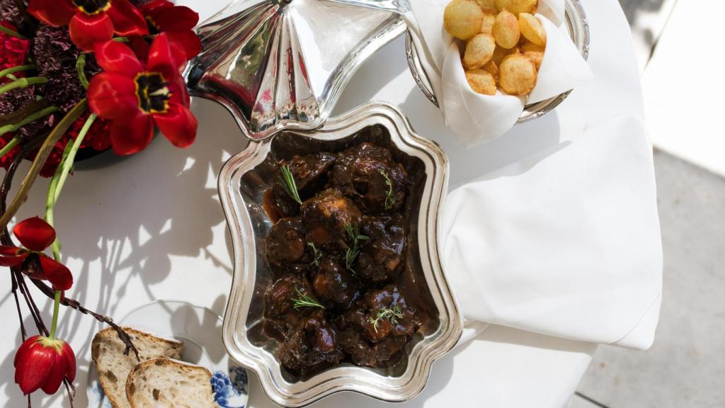 El rabo de toro estofado con las tradicionales patatas suflé.