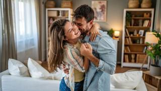 Pareja riendo mientras baila en el salón.