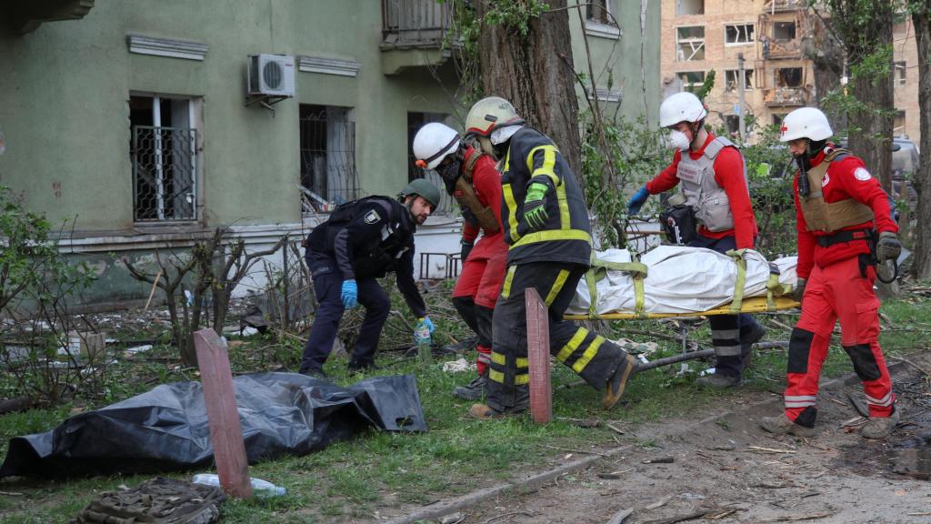 Los servicios de emergencia con varios cadáveres tras el ataque ruso sobre Kiev.
