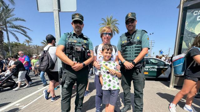 Madre e hijo en la parada de la Guardia Civil de Alicante en la romería de la Santa Faz.