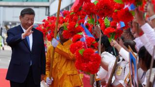 Chinese President Xi Jinping waves as he walks through Phnom Penh International Airport during his two-day visit to Cambodia, in Phnom Penh, Cambodia, April 17, 2025.
