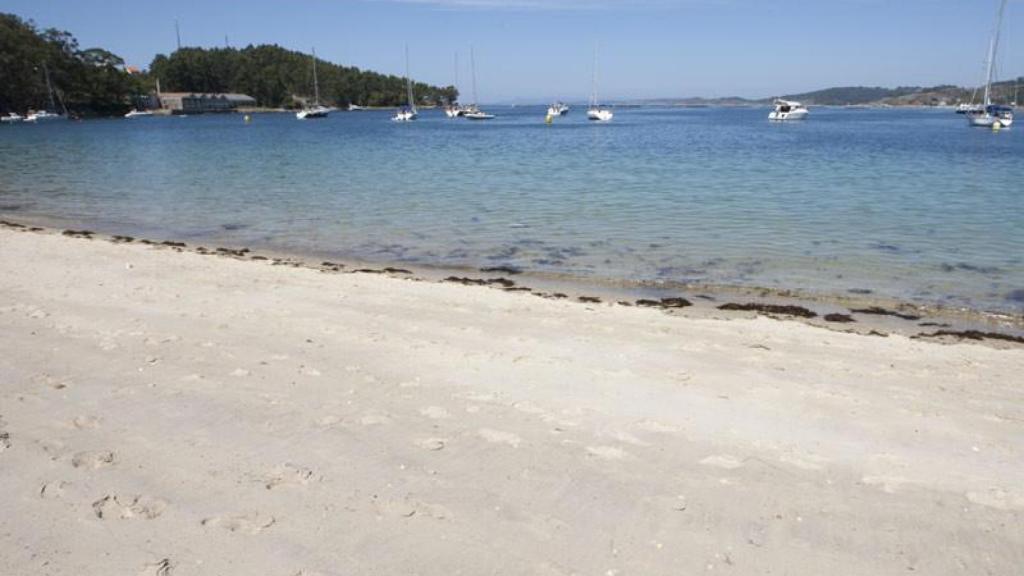 La playa de Arneles con embarcaciones fondeadas