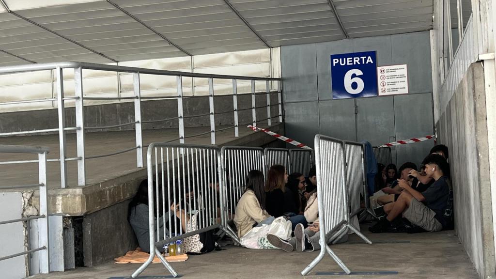 Un grupo de jóvenes espera en la puerta 6 del Coliseum.