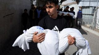 Un doliente sostiene un cuerpo durante el funeral de palestinos muertos en ataques israelíes, en el hospital bautista árabe Al-Ahli, en la Ciudad de Gaza, el 26 de mayo de 2025.