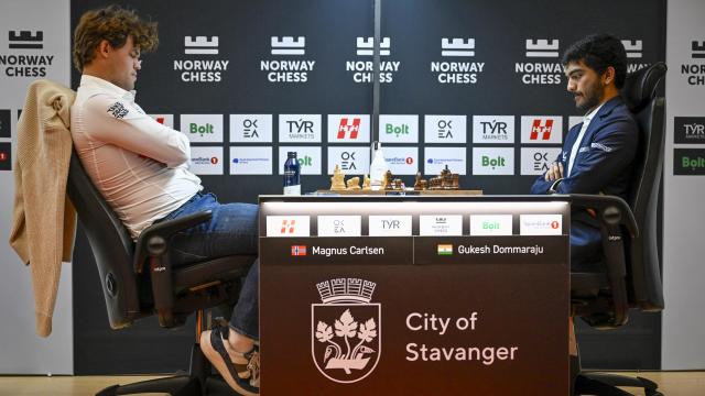 Magnus Carlsen (i) se enfrenta a Dommaraju Gukesh (d) durante una partida de ajedrez en Noruega.