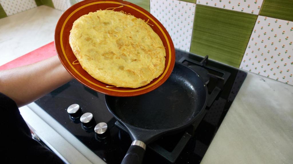 Una persona dando la vuelta a una tortilla