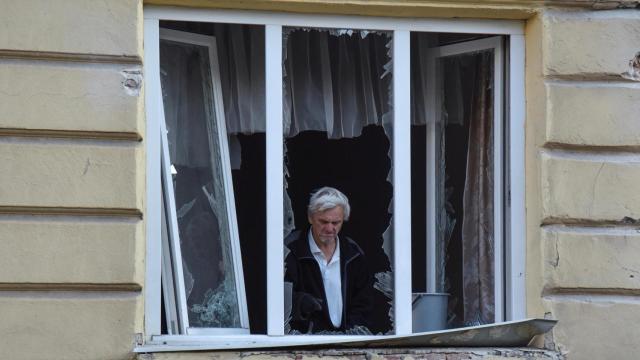Un residente retira el vidrio de una ventana rota de su apartamento que se dañó durante los ataques con drones y misiles rusos, en medio del ataque de Rusia a Ucrania , en Lviv, Ucrania , el 12 de julio de 2025.