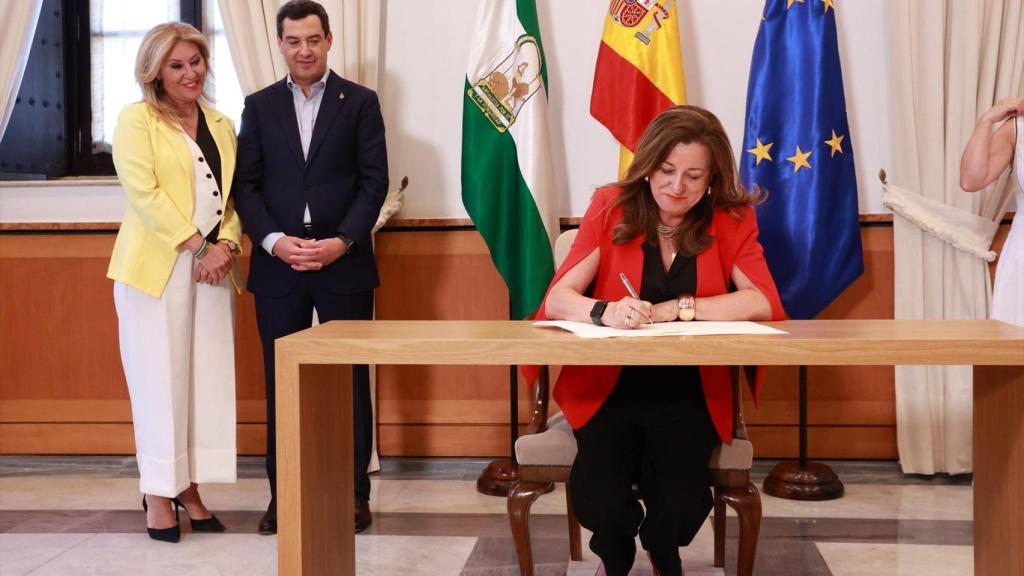 La consejera de Educación firma el acuerdo ante el presidente de la Junta y la consejera de Economía.
