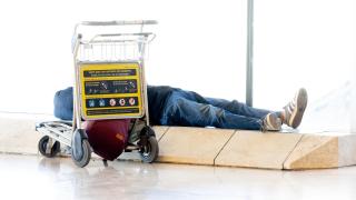 Una persona tumbada en la Terminal 4 del aeropuerto Adolfo Suárez Madrid-Barajas, a 24 de julio de 2025, en Madrid.