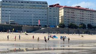 Varios coruñeses practicando deporte en la playa.