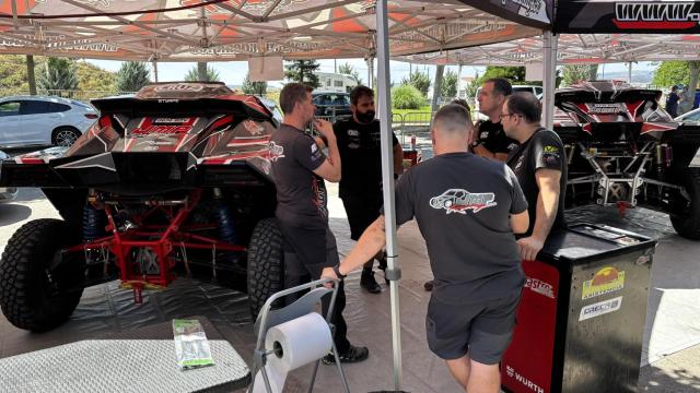 Mecánicos y técnicos de la escudería JMP Racing trabajando antes de una etapa de la Baja Aragón.
