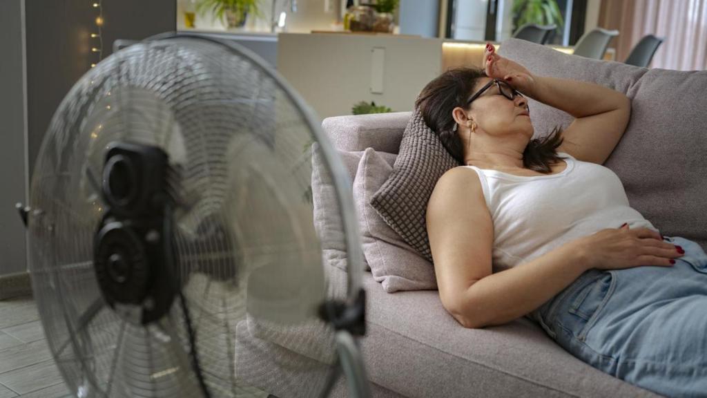 Mujer acostada frente al ventilador.