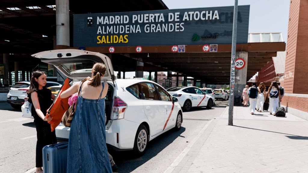 Unas mujeres cargan su equipaje en un taxi en la estación de Atocha de Madrid.
