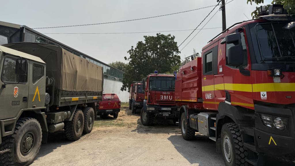 Frente a la piscina municipal, los vehículos permanecen aparcados, preparados para volver a salir.