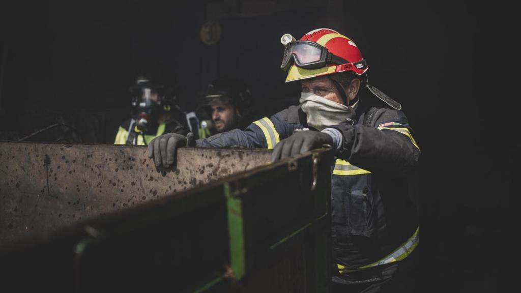 Faúndez colabora con los bomberos para sacar un tractor de una nave.