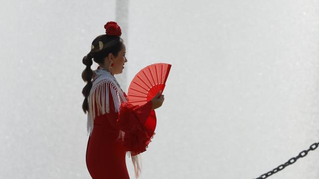 Una mujer vestida de flamenco en la Feria de Málaga.