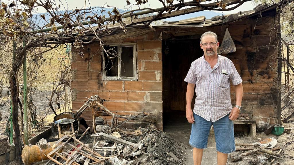 Ángel Gil, vecino de Jarilla, el epicentro del mayor incendio que arrasa en Extremadura, posa para EL ESPAÑOL en la puerta de su casa, aún con cenizas.