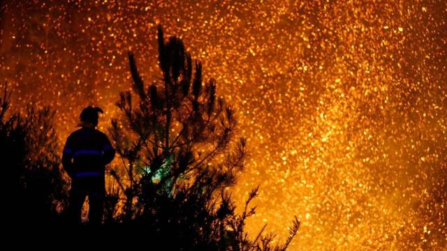 Un vecino ve el avance del fuego, a 25 de agosto de 2025, en A Pobra de Brollón, Lugo, Galicia (España)
