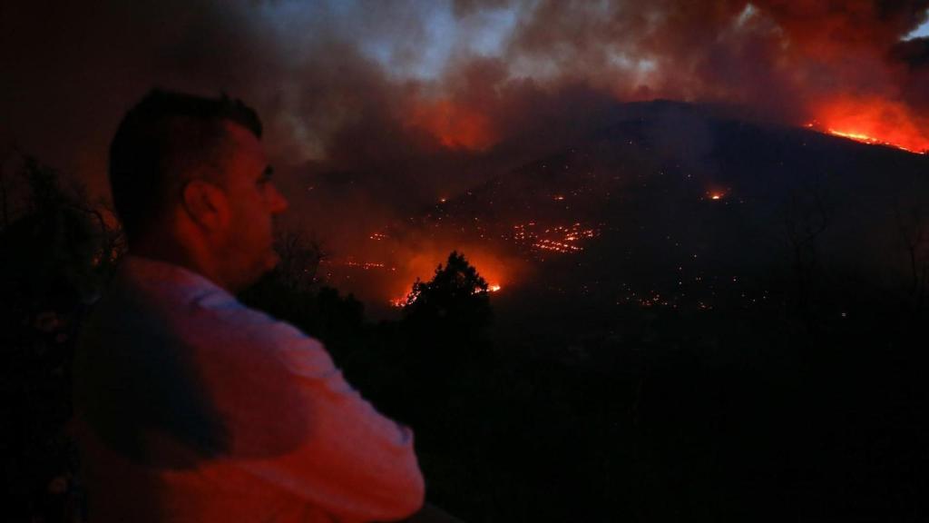 Vecinos ven el avance del fuego, a 25 de agosto de 2025, en A Pobra de Brollón, Lugo, Galicia (España).