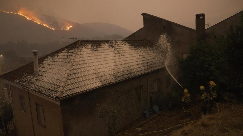 Varios bomberos forestales tratan de extinguir un fuego, a 17 de agosto de 2025, en Retorta, Laza, Ourense, Galicia (España).
