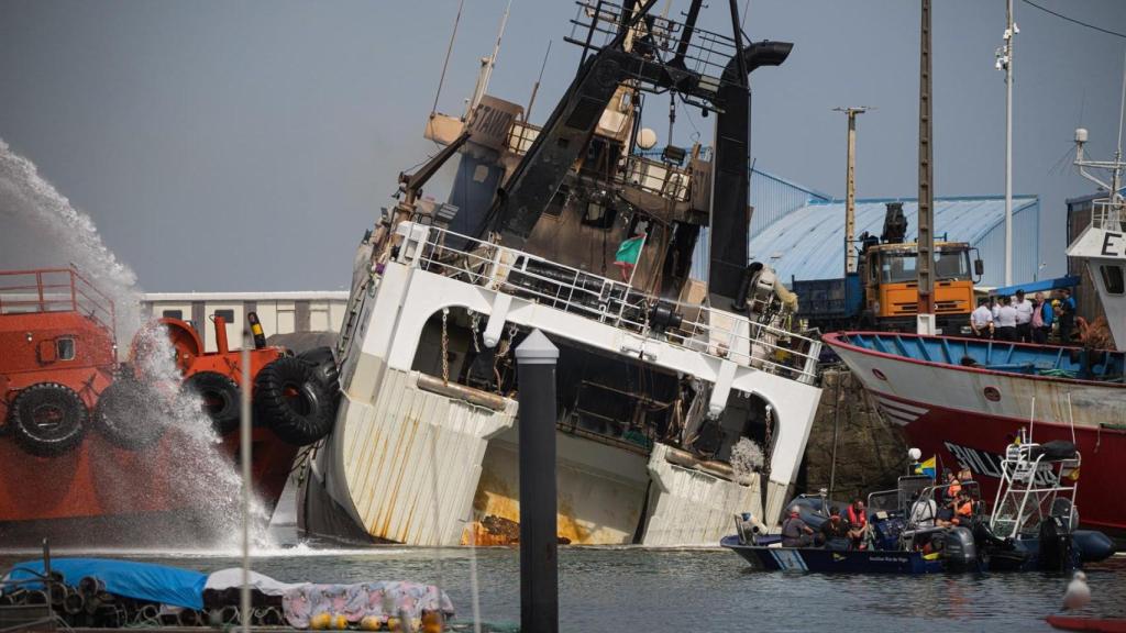 Agentes de los Servicios de Emergencias trabajan por apagar el incendio del buque Awadi, en el puerto de Ribeira, a 2 de septiembre de 2025.