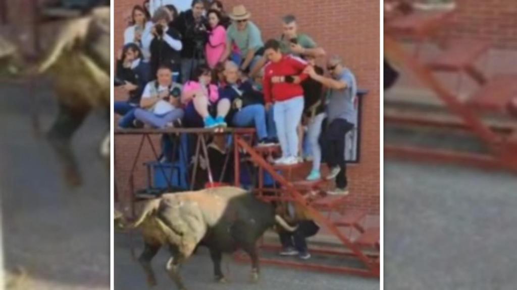 Un toro embiste contra la escalera y tira la plataforma donde estaba subido un grupo de personas