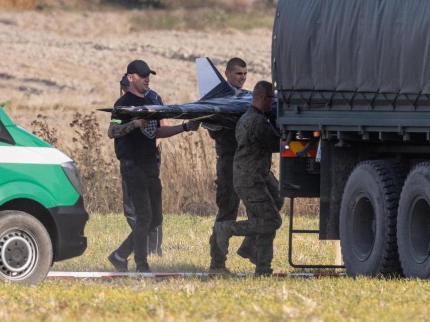 Miembros del ejército polaco recogen uno de los drones que violaron el espacio aéreo polaco en Wohyn.